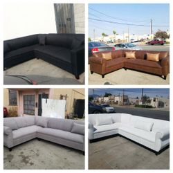 Brand NEW 7X9FT SECTIONAL COUCHES. DOMINO BLACK, LIGHT GREY FABRIC, DAKOTA CAMEL, WHITE LEATHER SECTIONAL COUCHES. 