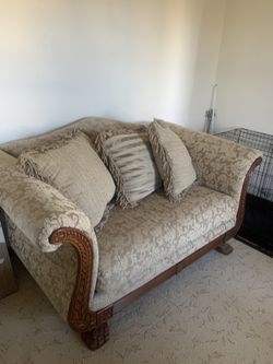 Couch And Loveseat With Wood Trim And Pillows