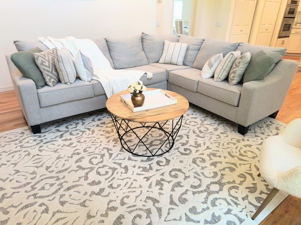Complete Living Room: Sectional couch, 9 neutral cushions, rug & 2 arm Chairs. 