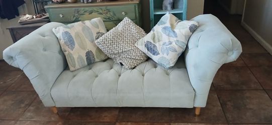 Light green couch with cushions included