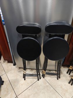 Two foldable black chairs