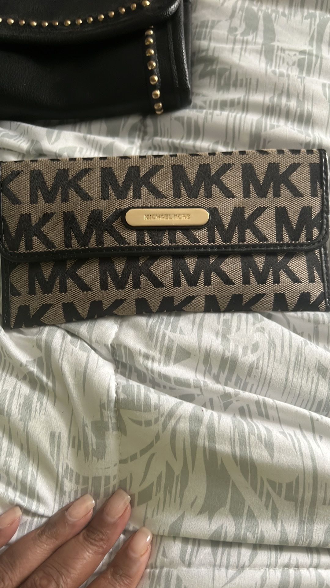 Michael Kors Black Canvas Wallet  MK on from and back of wallet. Gold Michael Kors plate on front and back zipper. Credit card slots, back zipper, and