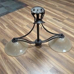 3-light chandelier with glass bowls in the shape of a bell stained with tea and rolls and square arms, forged bronze