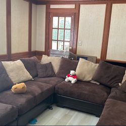 brown sectional sofa with 12 full pillows and 2 minis