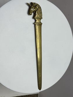 A vintage letter opener shaped like a horse's head