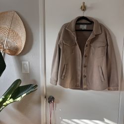 Tan and brown fleece like jacket with pockets