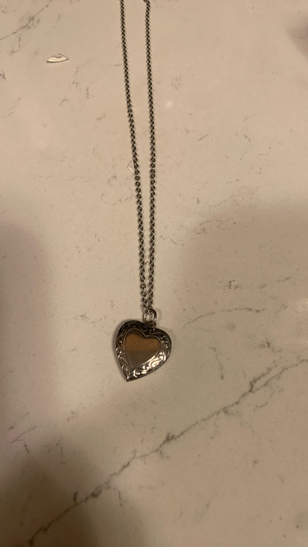 Silver color necklace with a heart