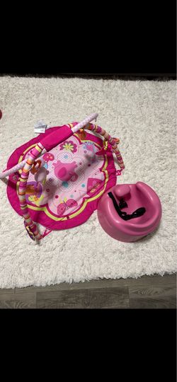 Pink floor mat and bumbo chair