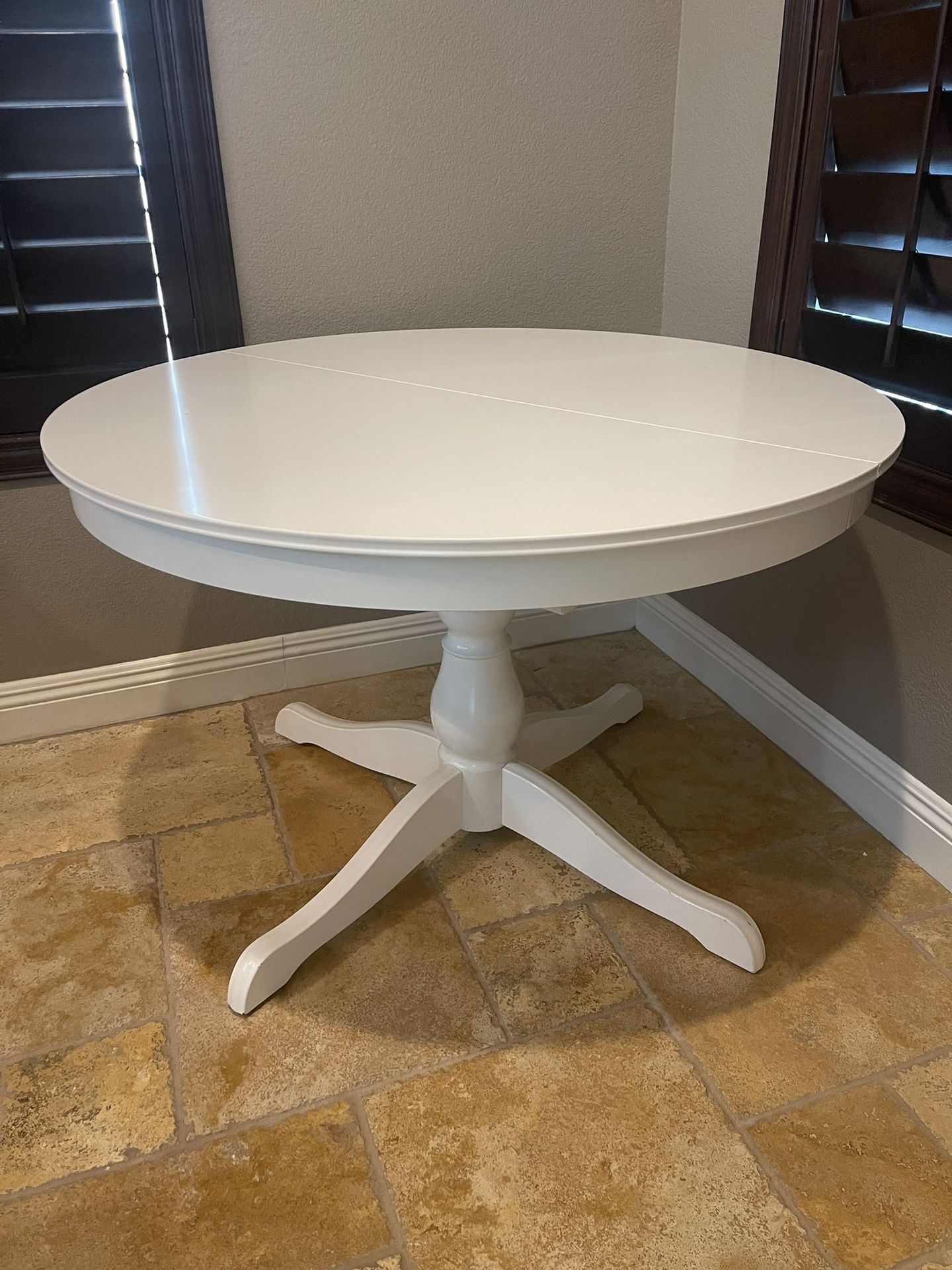 Round extendable wooden dining table