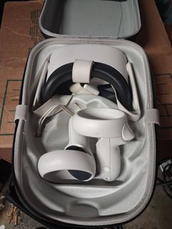 Meta Quest 2 virtual reality headset with its two matching touch controllers.