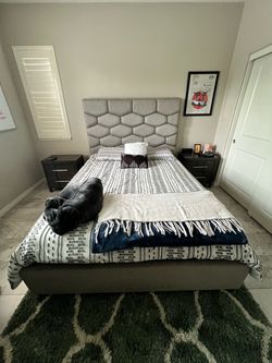 Grey cushioned bed frame queen