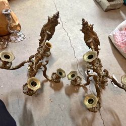 Ornate antique French Rococo-style brass candelabras.  Candelabras, designed to hold multiple candles, have been a symbol of wealth and status since a