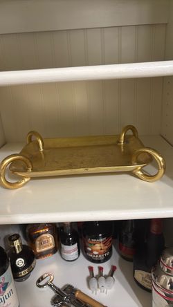 Gold jewelry, wallet, candle, and key tray