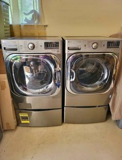 LG 9.0 cu. Ft. Mega capacity electric dryer w/ true steam with laundry pedestal.