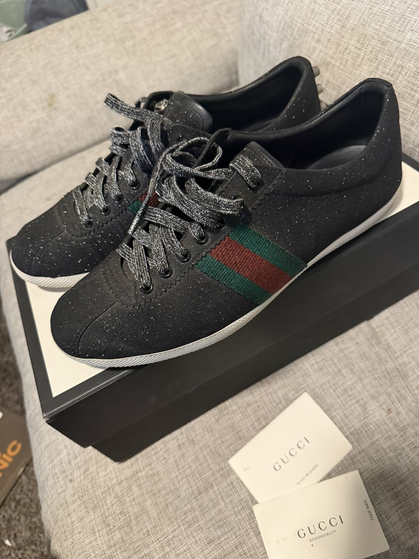 Gucci Bambi Web low-top sneakers in black glitter fabric with signature green and red webbing and silver-toned studs at the heel.