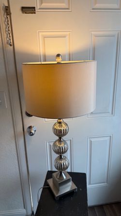 Table lamp with three stacked silvered-glass spheres on a silver pedestal