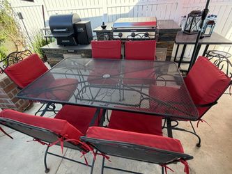 Wrought iron table and 6 chairs and cushions