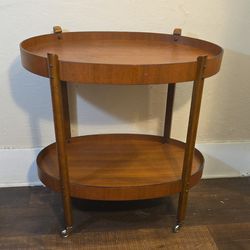 Mahogany Serving Table. 29"tall x 26"lenth x 17"width, Metal Castor Wheels, In Good Condition.