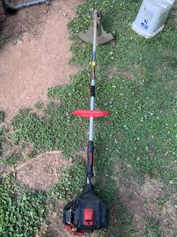 pole Tough weed eater red black with a silver pole
