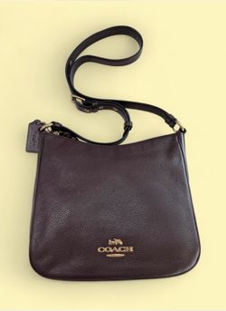 Coach Ellie File Bag in oxblood color featuring a gold-toned logo.