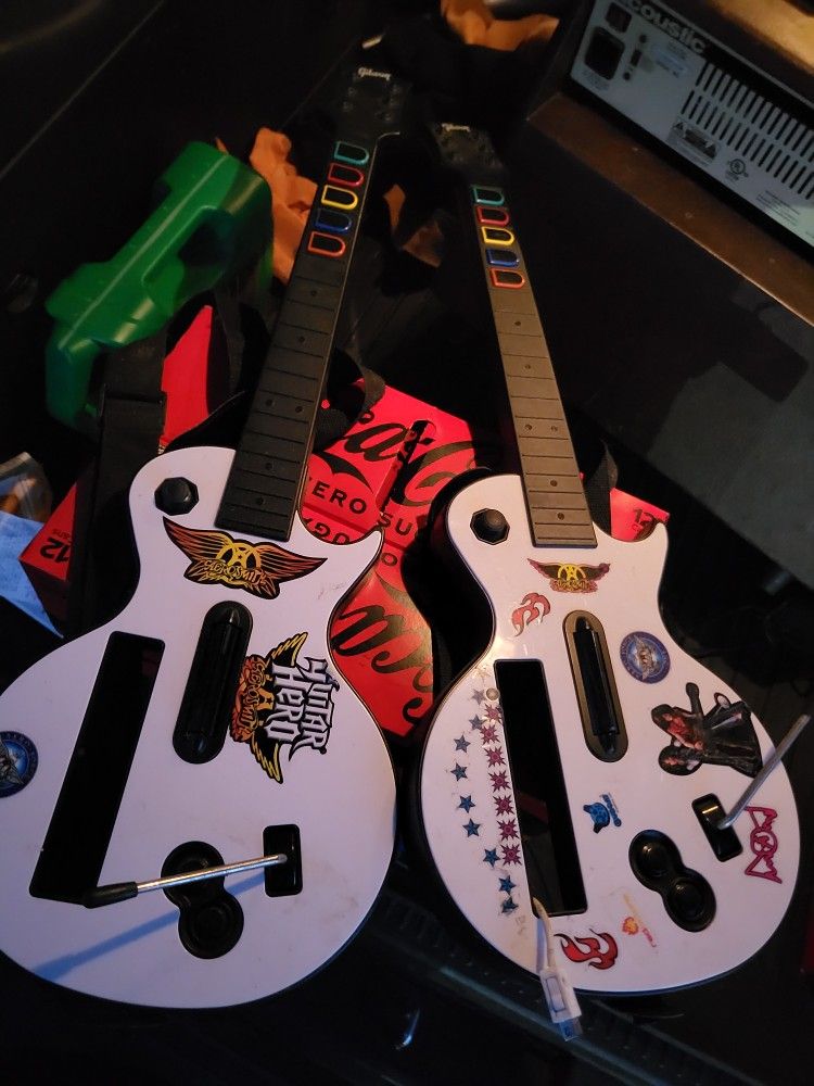 2 Nintendo wii guitar hero guitars 
With straps great condition.