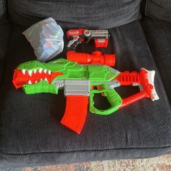 A Nerf gun with a pistol with a bag full of ammo