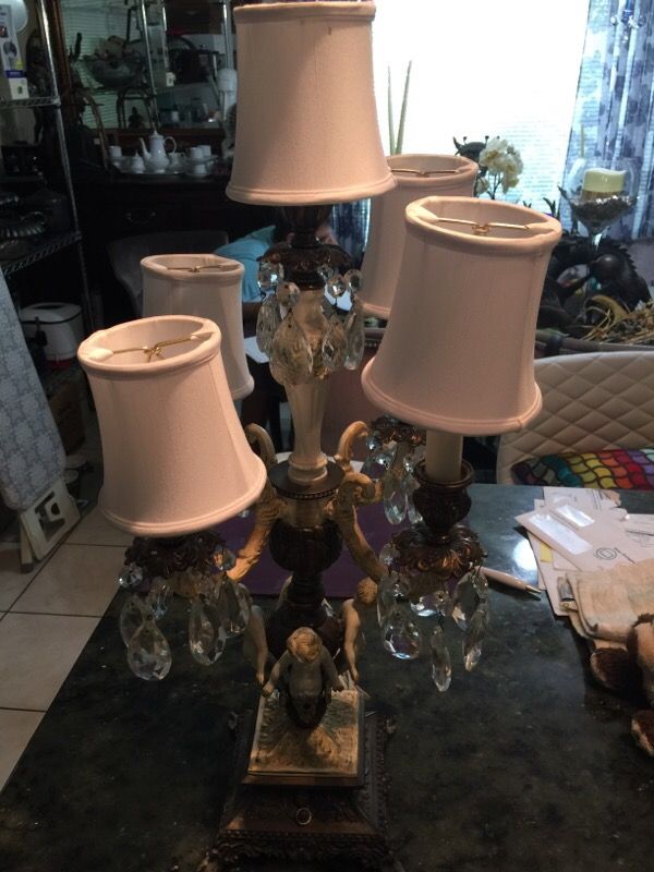 Antique brass and glass crystal upright table top chandelier, 5 candelabra lights with white silk shades and four ornate cherubs. 26" tall