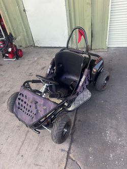 Awesome Go-Bowen go-kart. Black frame with a comfy seat. Has seatbelt for safety. Metal diamond plate footrests. Red safety flag on the back. Tires lo