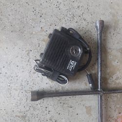 Tire inflater and 4 way tire iron and 2 sets of jumper cables 