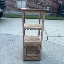Rustic wooden accent cabinet with shelves and door