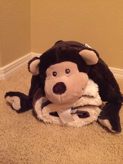 Baby blanket wrapped in an stuffed animal