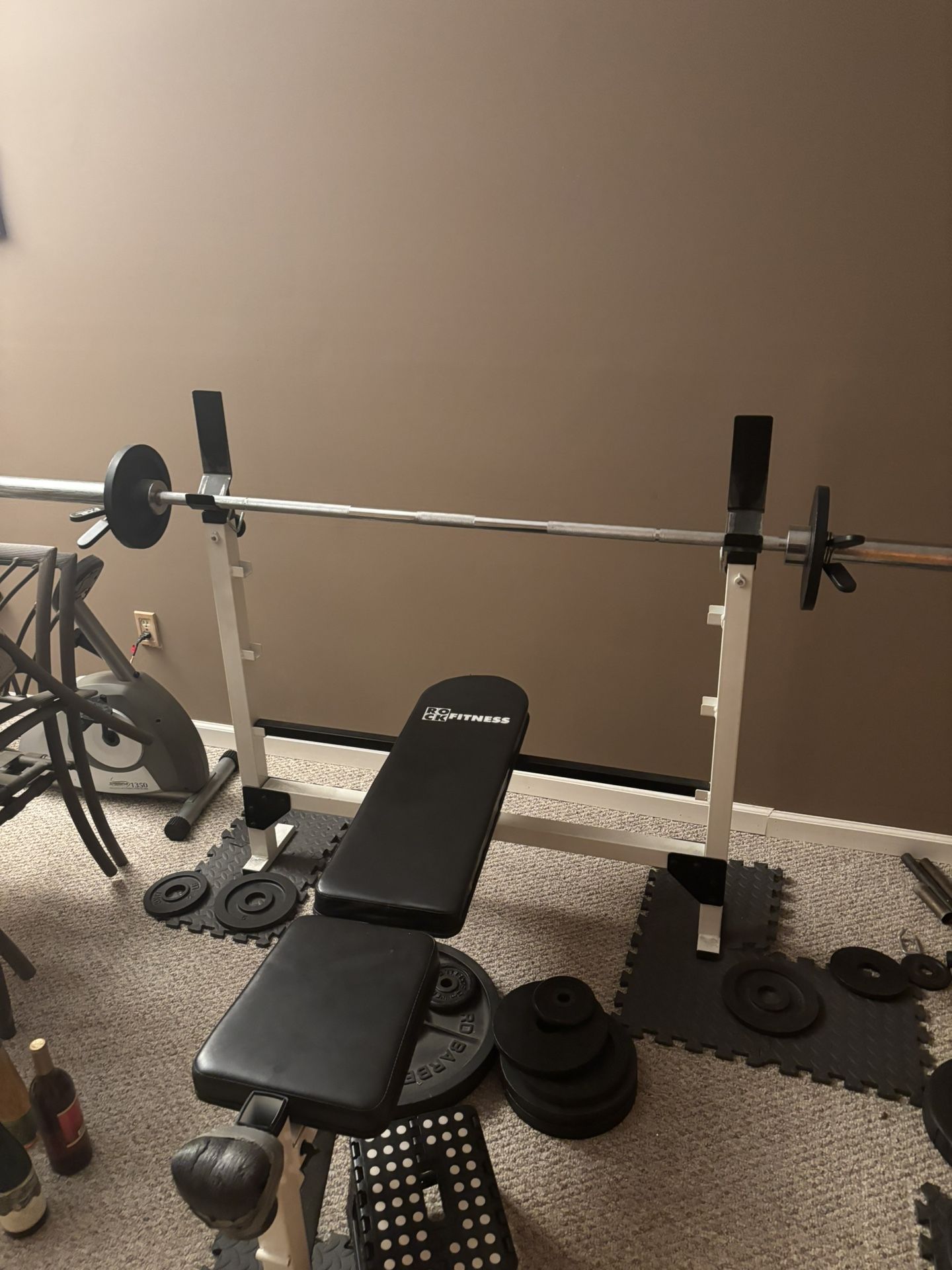 bench press with a bunch of weights and other workout equipment throw me an offer