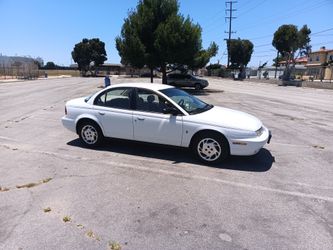 97 Saturn four-door sedan