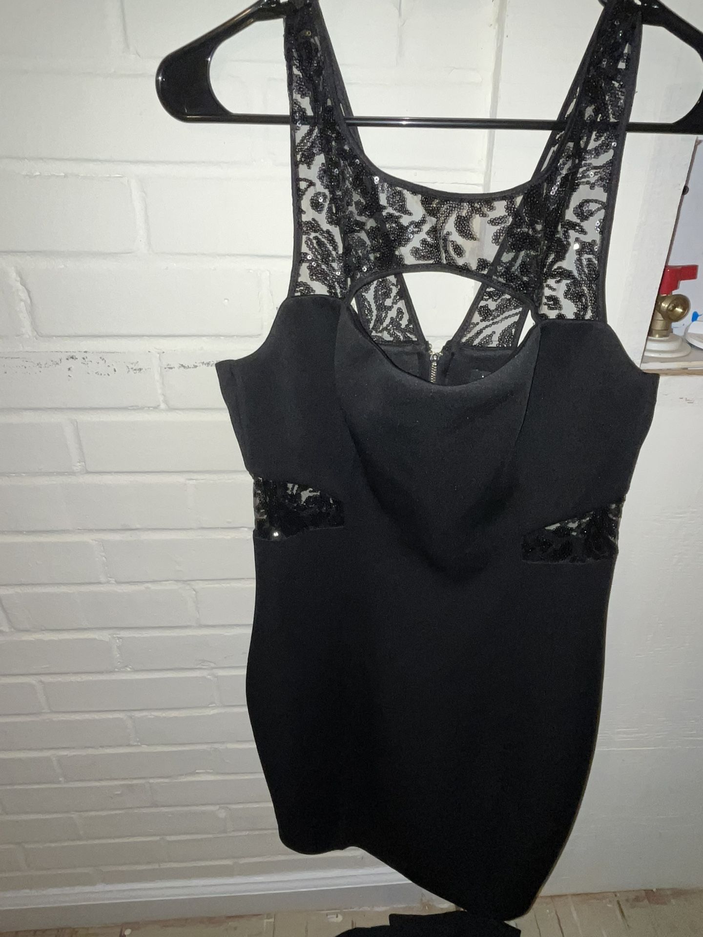 a black, form-fitting mini dress by Guess