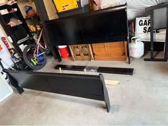 Black wooden bed frame, long dresser with mirror and night stand