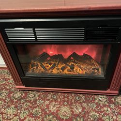 Heat Surge electric portable fireplace heater is in great condition.  Wood mantle is Amish