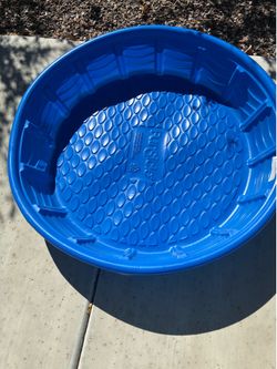 Child’s blue plastic swimming pool
