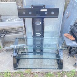 This is a Z-Line TV stand with a built-in mount, featuring black metal legs and tempered glass shelves