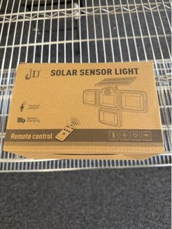 Solar sensor light with solar panel and remote
