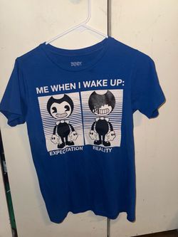 bright blue Bendy and the Ink Machine graphic t-shirt featuring the character Bendy in a  two-panel "Expectation vs. Reality" morning graphic under th