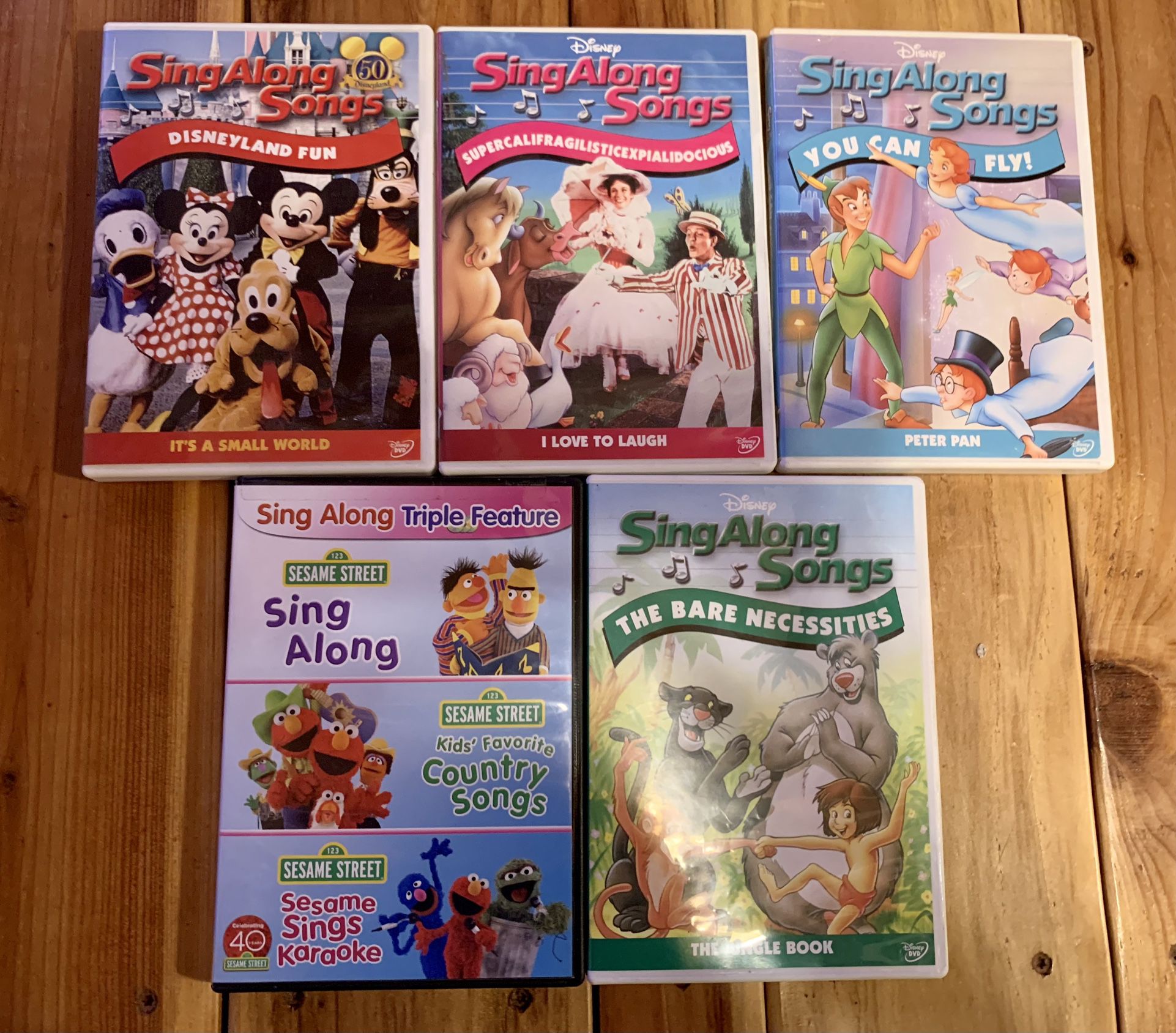 DVDs Of Four Assorted Disney Sing Along Songs  & One Sesame Street TRIPLE Disc Sing Along 
