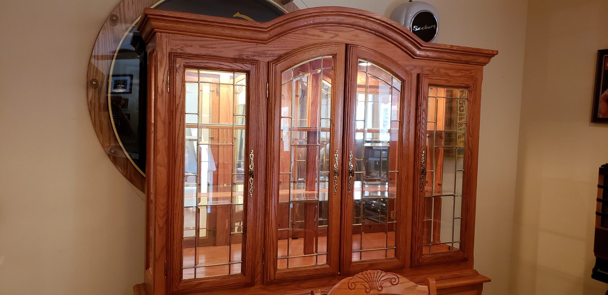 Beautiful lighted OAK Buffet Hutch with drawers, cabinets, glass shelves, and mirror back glass.