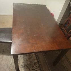 wooden table and two chairs 