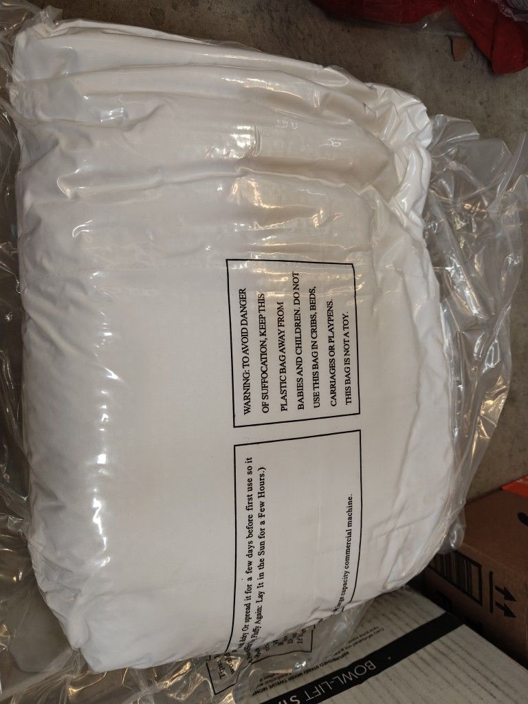 White mattress pad vacuum sealed, size unknown