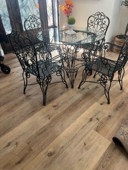 Wrought iron table, glass table with 4 chairs