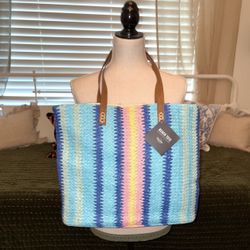 This is a Martha Stewart beach tote bag with a striped, multi-colored design and leather straps