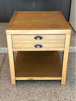 Wood Nightstand/Side table featuring a light driftwood finish and dark metal hardware.