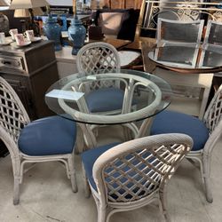 vintage white rattan dining set with a glass top table and blue cushions - 36”