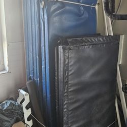 Stack of folding/roll-up wrestling / martial arts mats
