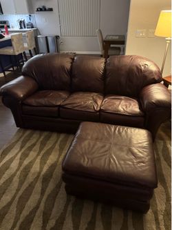 Burgundy leather couch with foot stool